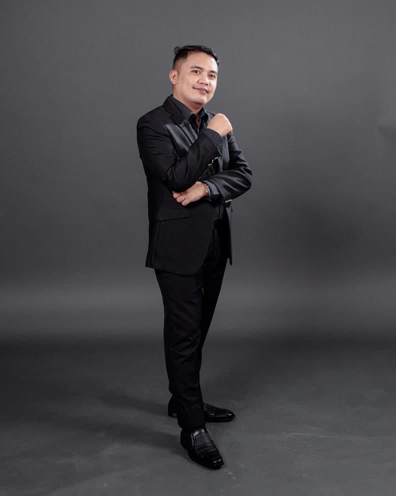Rodel Hermogenes, licensed financial advisor with Sun Life, in a black suit